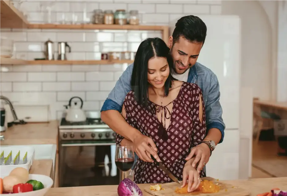 Couple cooking together in kitchen